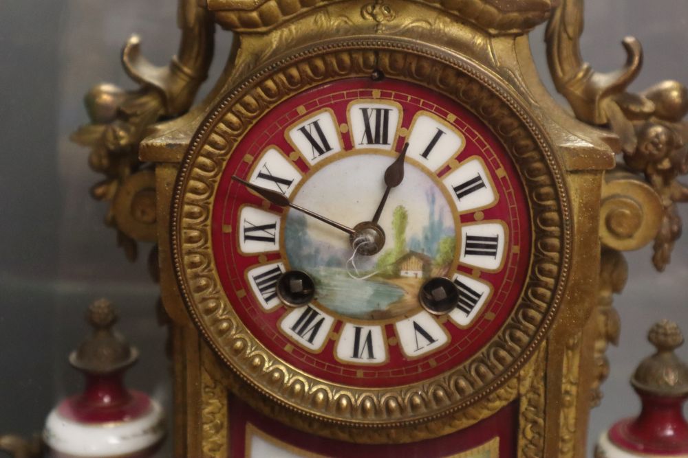 A 19th century French Louis XV style gilt spelter and porcelain mounted eight day mantel clock, on plinth, under a glass dome, with pen